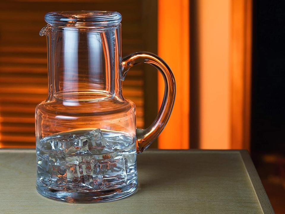 So you can quench that middle-of-the-night thirst without having to make that dreadful walk to the fridge.<br /><br /><strong>Promising review:</strong> "My wife often gets up in the middle of the night for water and she wanted something close by and not have to go to the refrigerator. This carafe is absolutely perfect for her. First, it is very high quality, exquisitely made, and holds just the right amount of water/ice for keeping on the nightstand overnight. For all day, you'd want an insulated tumbler perhaps, but she fills this halfway with ice cubes and fills enough water just to the neck. it stays cold all night. Any leftover water, she just waters her plants with. My wife and I both have difficulty lifting some objects, but this glass carafe, though solid and substantial, has a very big glass handle so it is easy for her to pour water into the included cup and cover. It came quite fast, extremely well-packed to prevent breakage, and should serve her well for many years." &mdash; <a href="https://www.amazon.com/gp/customer-reviews/RDCLWVQ9DMZC4?&amp;linkCode=ll2&amp;tag=huffpost-bfsyndication-20&amp;linkId=e15f91a31aec813aa01d973b0736be89&amp;language=en_US&amp;ref_=as_li_ss_tl" target="_blank" rel="noopener noreferrer">Bob Foss</a><br /><br /><strong><a href="https://www.amazon.com/dp/B075Y4YJ2S?&amp;linkCode=ll1&amp;tag=huffpost-bfsyndication-20&amp;linkId=baf15351ee25215f4642984eb9497dae&amp;language=en_US&amp;ref_=as_li_ss_tl" target="_blank" rel="noopener noreferrer">Get it from Amazon for $44.95.</a></strong>