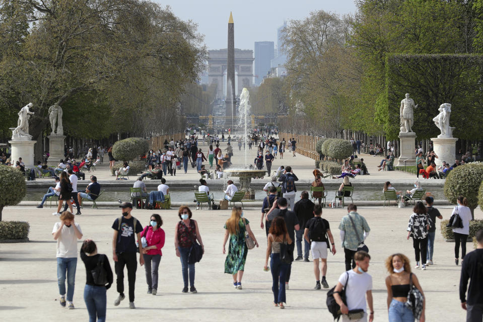 FILE - In this April 1, 2021, file photo, people wear face mask as they walk in a path of the Tuileries garden in Paris. European countries scrambled Monday, April 5 to tamp down a surge in COVID-19 cases and ramp up vaccinations, hoping to spare hospitals from becoming overwhelmed by the pandemic's latest deadly wave of infections. (AP Photo/Thibault Camus, File)