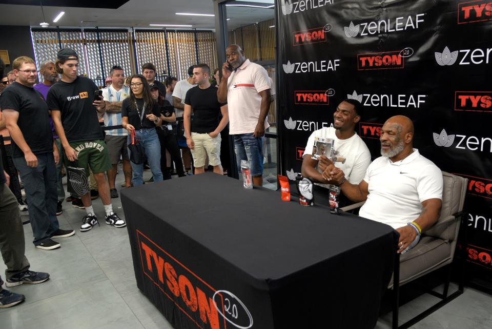 Sergio Garcia has his photo taken with Mike Tyson and a bobblehead of Tyson at Zen Leaf in Neptune Township, New Jersey on Saturday, September 3, 2022. Tyson’s visit was to promote his cannabis brand Tyson 2.0 and retired professional wrestler Ric Flair’s cannabis line Ric Flair Drip.