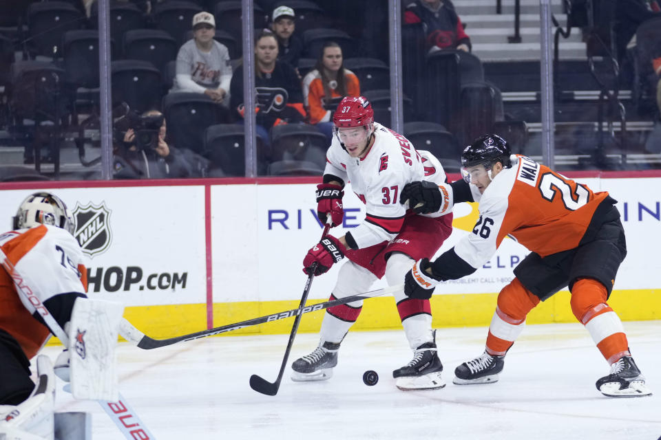 Carolina Hurricanes' Andrei Svechnikov (37) tries to get past Philadelphia Flyers' Sean Walker (26) during the third period of an NHL hockey game, Monday, Oct. 30, 2023, in Philadelphia. (AP Photo/Matt Slocum)