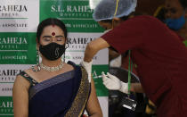 A health worker administers the Covishield vaccine against the coronavirus at a vaccination program for members of the transgender community in Mumbai, India, Sunday, June 20, 2021. (AP Photo/Rafiq Maqbool)