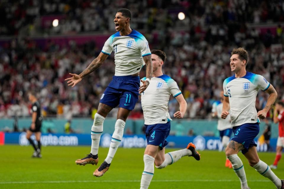 Rashford fired home two goals to help England into the last 16 (AP)