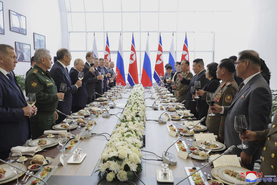 In this photo provided by the North Korean government, Russian President Vladimir Putin, fourth left, and North Korean leader Kim Jong Un, fourth right, toast after their talk at the Vostochny cosmodrome outside the city of Tsiolkovsky, about 200 kilometers (125 miles) from the city of Blagoveshchensk in the far eastern Amur region, Russia, Wednesday, Sept. 13, 2023. Independent journalists were not given access to cover the event depicted in this image distributed by the North Korean government. The content of this image is as provided and cannot be independently verified. Korean language watermark on image as provided by source reads: "KCNA" which is the abbreviation for Korean Central News Agency. (Korean Central News Agency/Korea News Service via AP)