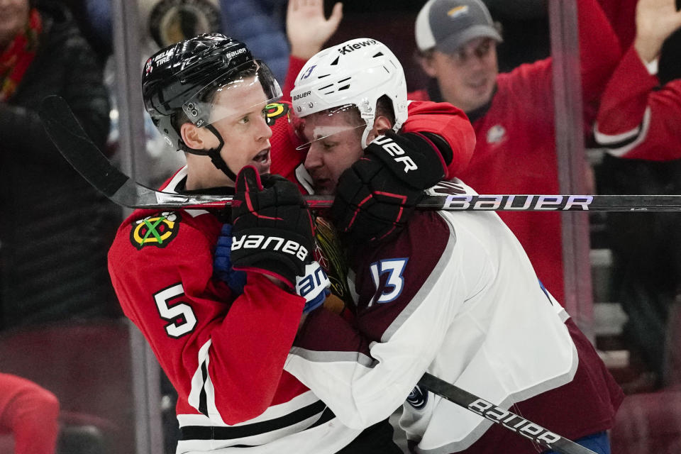 Chicago Blackhawks defenseman Connor Murphy, left, and Colorado Avalanche right wing Valeri Nichushkin scuffle during the third period of an NHL hockey game Tuesday, Dec. 19, 2023, in Chicago. The Blackhawks won 3-2. (AP Photo/Erin Hooley)