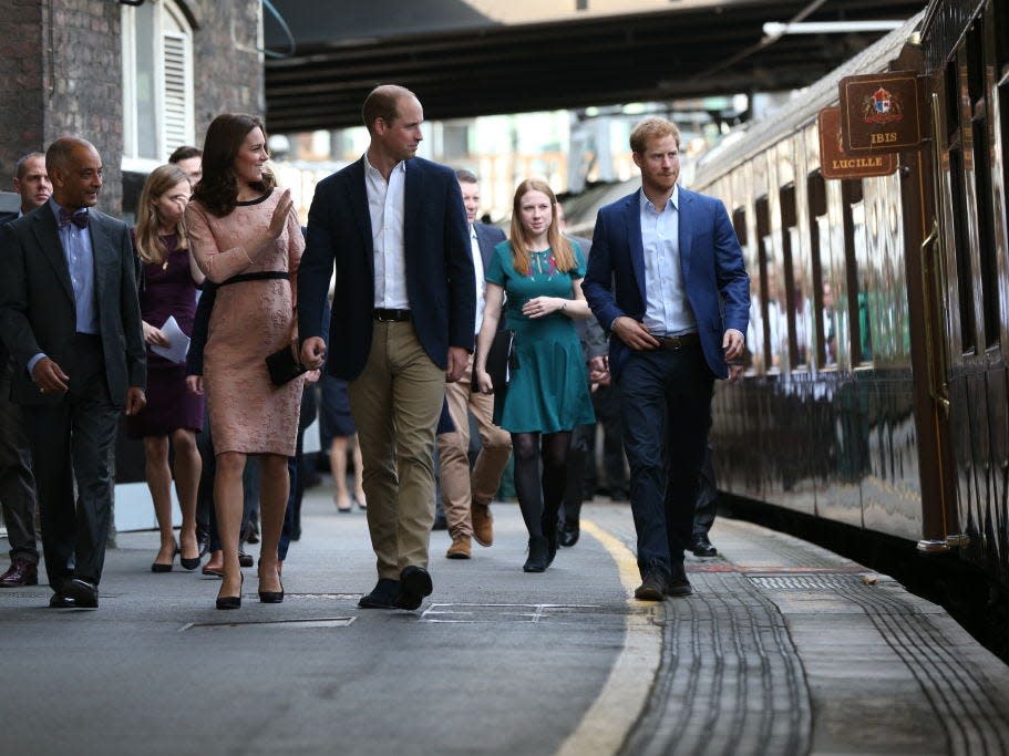 Kate Middleton, Prince William, and Prince Harry at a train station in 2017.