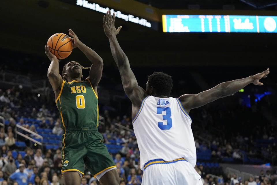 Norfolk State guard Christian Ings, left, shoots as UCLA forward Adem Bona defends during the first half of an NCAA college basketball game Monday, Nov. 14, 2022, in Los Angeles. (AP Photo/Mark J. Terrill)