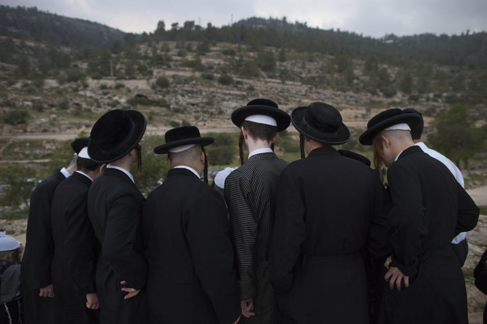 Ultra-Orthodox Jews collect water to make matza during the Maim Shelanoo ceremony at a mountain spring, near Jerusalem, Sunday, April 13, 2014. The water is used to prepare the traditional unleavened bread for the high holiday of Passover which begins Monday.(AP Photo/Dan Balilty)