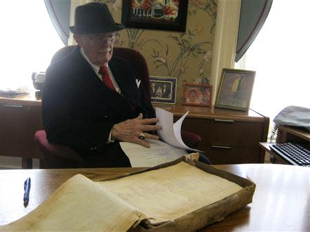 Dudley Martin looks at handwritten manuscripts written by Robert Stroud at his home in Springfield, Missouri, February 12, 2014. REUTERS/Kevin Murphy