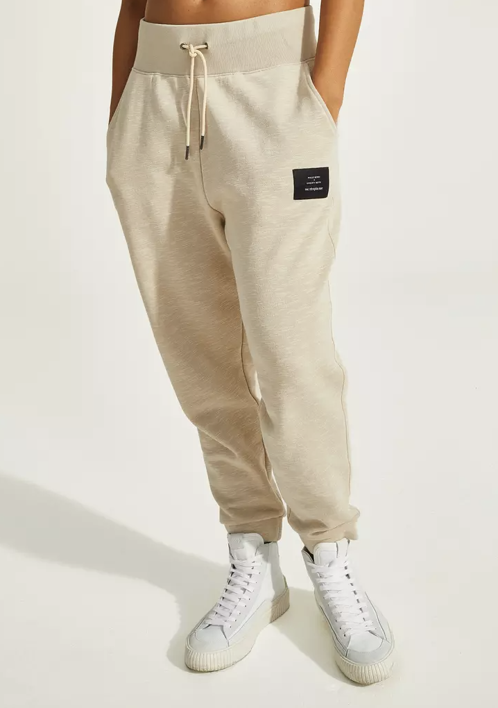 Beige sweatpants and white sneakers