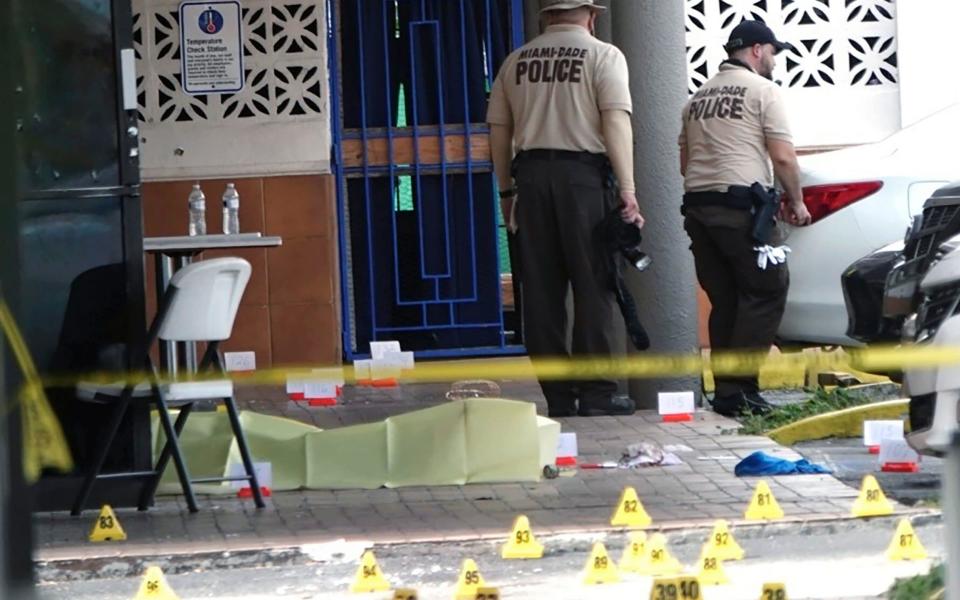 Miami-Dade Police work the scene of a shooting outside a banquet hall near Hialeah, Fla. - Joe Cavaretta/South Florida Sun-Sentinel