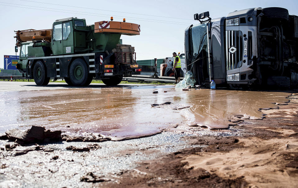 <p>Tons of liquid milk chocolate are spilled and block six lanes on a highway after a truck transporting it overturned near Slupca, in western Poland, on May 9, 2018. (Photo from AP) </p>