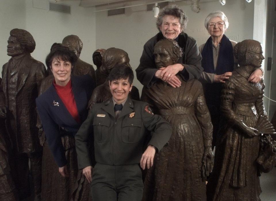 Some of the planners of Celebrate 98. From left: Lorie Barnum, Josie Fernandez, Nan Johnson and Mary Ann Krupsak, posting at the visitors center of the Women's National Historic Park in Seneca Falls with statues of the original signers of the Declaration of Sentiments.