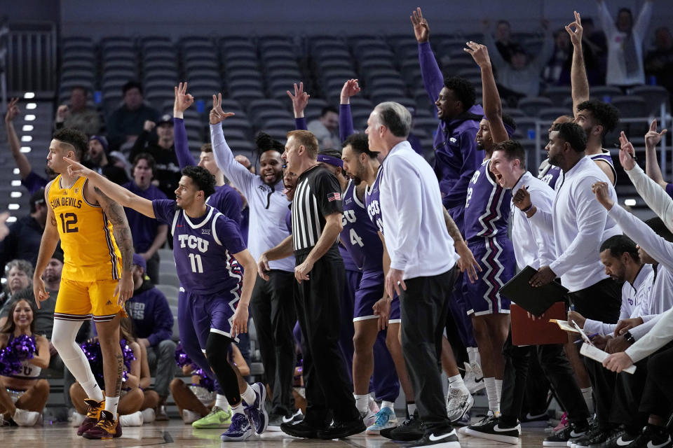 TCU guard Trevian Tennyson (11) and the bench celebrate near Arizona State guard Jose Perez (12) after Tennyson sunk a 3-point basket during the second half of an NCAA college basketball game in Fort Worth, Texas, Saturday, Dec. 16, 2023. (AP Photo/Tony Gutierrez)