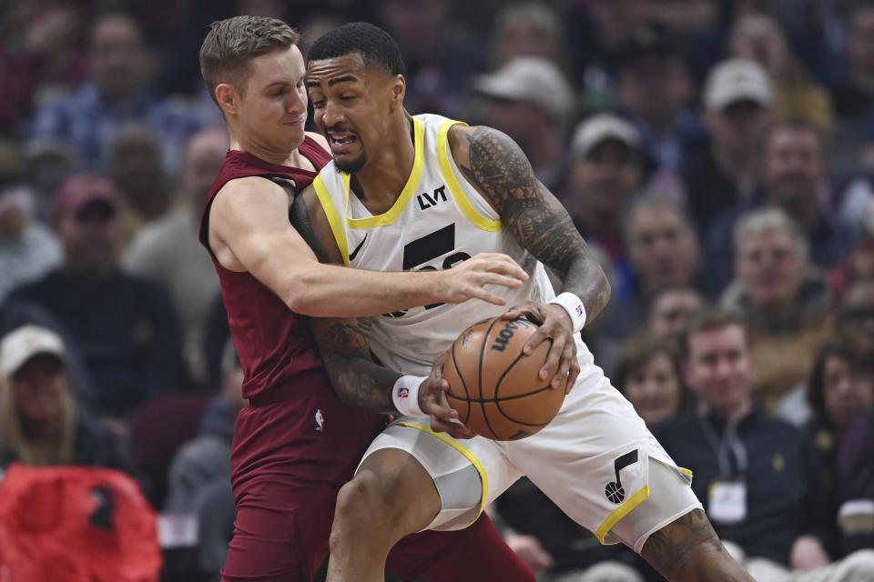 Utah Jazz forward John Collins drives on Cleveland Cavaliers guard Sam Merrill during game Wednesday, Dec. 20, 2023, in Cleveland. The former Aggie has always known how to shoot the rock, but his defense has also impressed Cleveland coach J.B. Bickerstaff. | David Dermer, Associated Press
