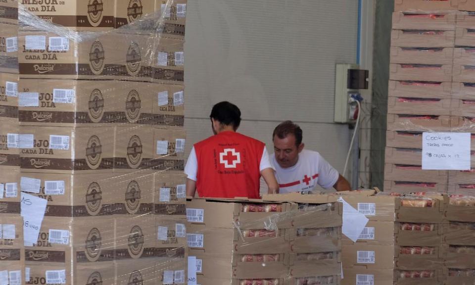 Red Cross volunteers store food at the logistical centre in Valencia in Spain