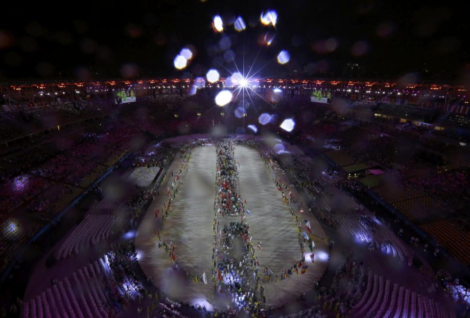 <p>Flag-bearers hold their national flags as they take part in the closing ceremony. REUTERS/Fabrizio Bensch </p>