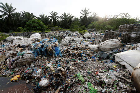 Scrap from an illegal plastic recycling factory are dumped near a palm oil plantation in Jenjarom, Kuala Langat, Malaysia October 14, 2018. REUTERS/Lai Seng Sin/Files