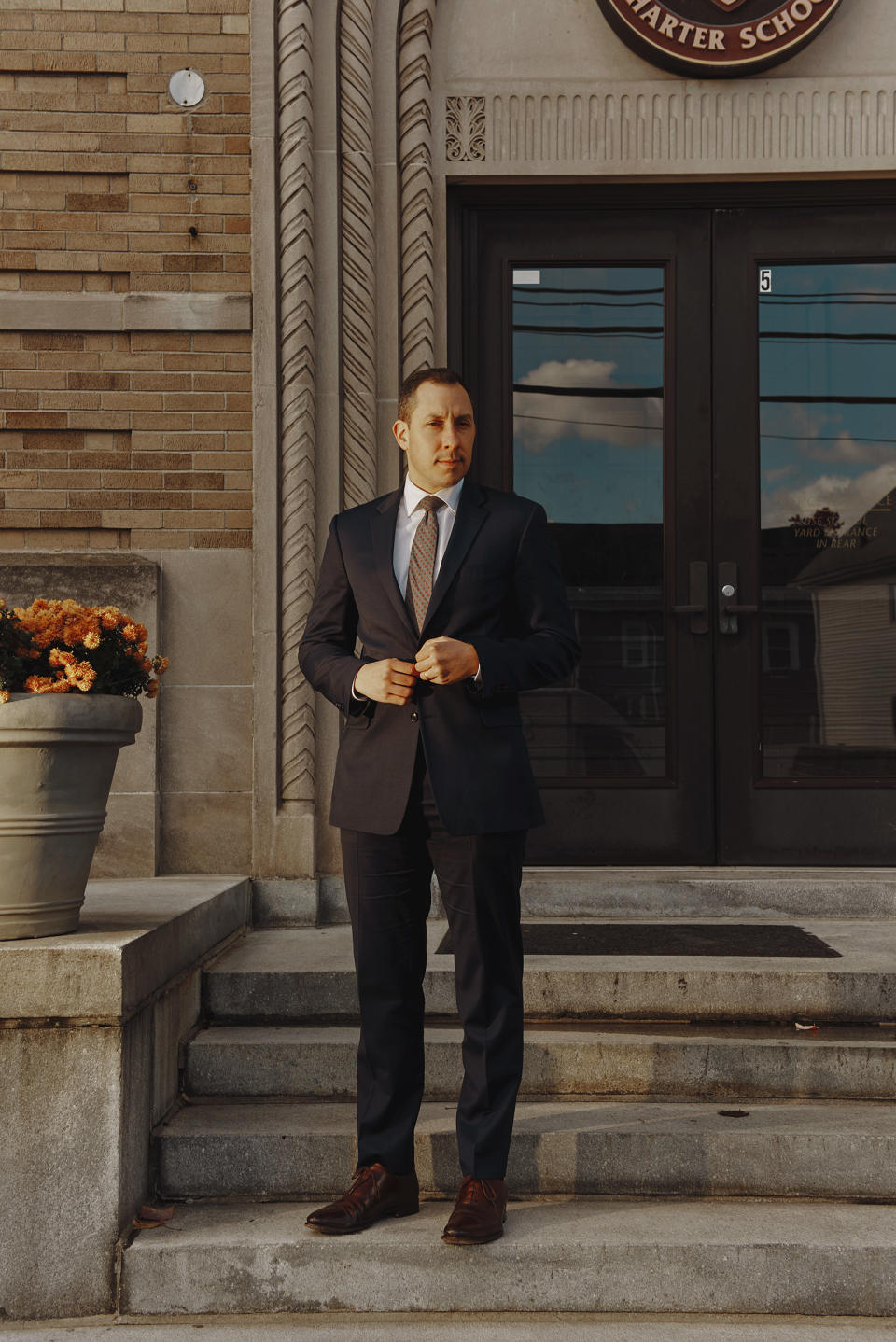 Alex Dan, director and superintendent of the Mystic Valley Charter School, on the steps of the high school in Malden on Nov. 19<span class="copyright">Tony Luong for TIME</span>