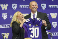 Washington athletic director Jen Cohen, left, poses for a photo with Kalen DeBoer, right, Tuesday, Nov. 30, 2021, during a news conference in Seattle to introduce DeBoer as the new head NCAA college football coach at the University of Washington. DeBoer has spent the past two seasons as head football coach at Fresno State. (AP Photo/Ted S. Warren)