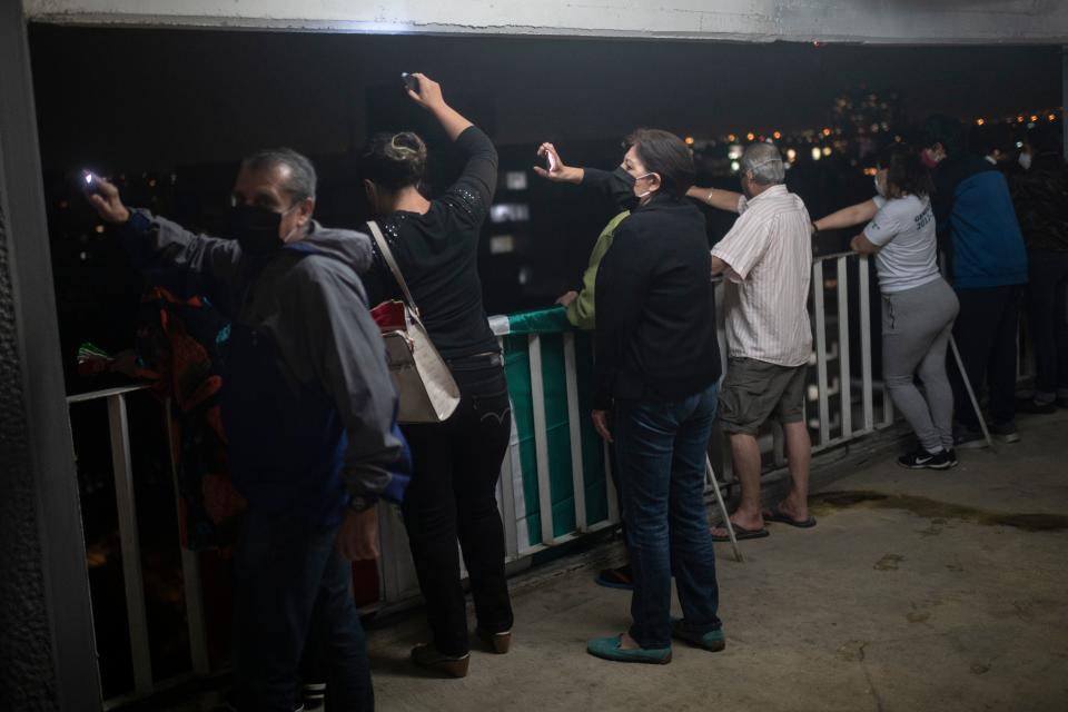 Residents of a building across the "20 de Noviembre" hospital sing and wave lights to praise medical staff and patients in Mexico City, on April 28, 2020, amid the novel coronavirus pandemic. - Latin America is like "Europe six weeks ago" in relation to the advance of COVID-19, so an increase in the number of cases is expected in the coming weeks, warned on April 28 the deputy director of the Pan American Health Organization (PAHO), Jarbas Barbosa. (Photo by PEDRO PARDO / AFP) (Photo by PEDRO PARDO/AFP via Getty Images)