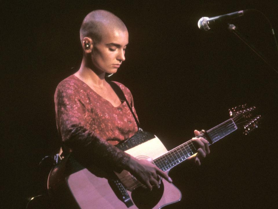 Sinead O'Connor is shown performing on stage during a live concert appearance on August 21, 1990