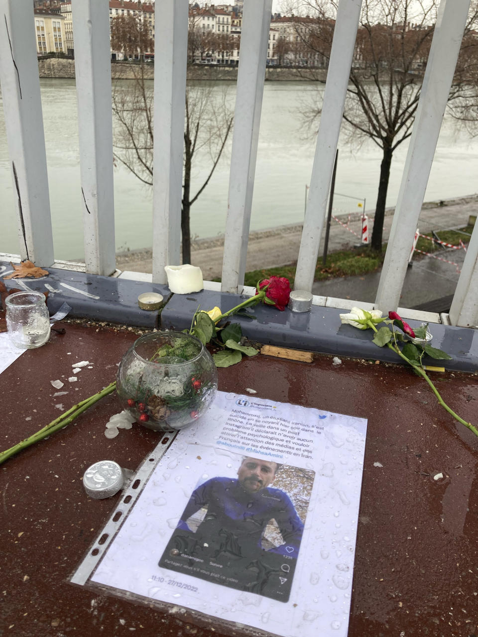 A picture of Mohammad Moradi, an Iranian activist who took his own life after jumping in the Rhone river in the French city of Lyon, lies on the floor, Friday, Dec. 30, 2022. When a 38-year-old man anguished over the protests in Iran took his own life in the French city of Lyon, fellow members of the Iranian diaspora felt his pain. Three months into the anti-government protests that have swept Iran, Iranians abroad are going through a spectrum of emotions. (AP Photo/Nicolas Vaux-Montagny)