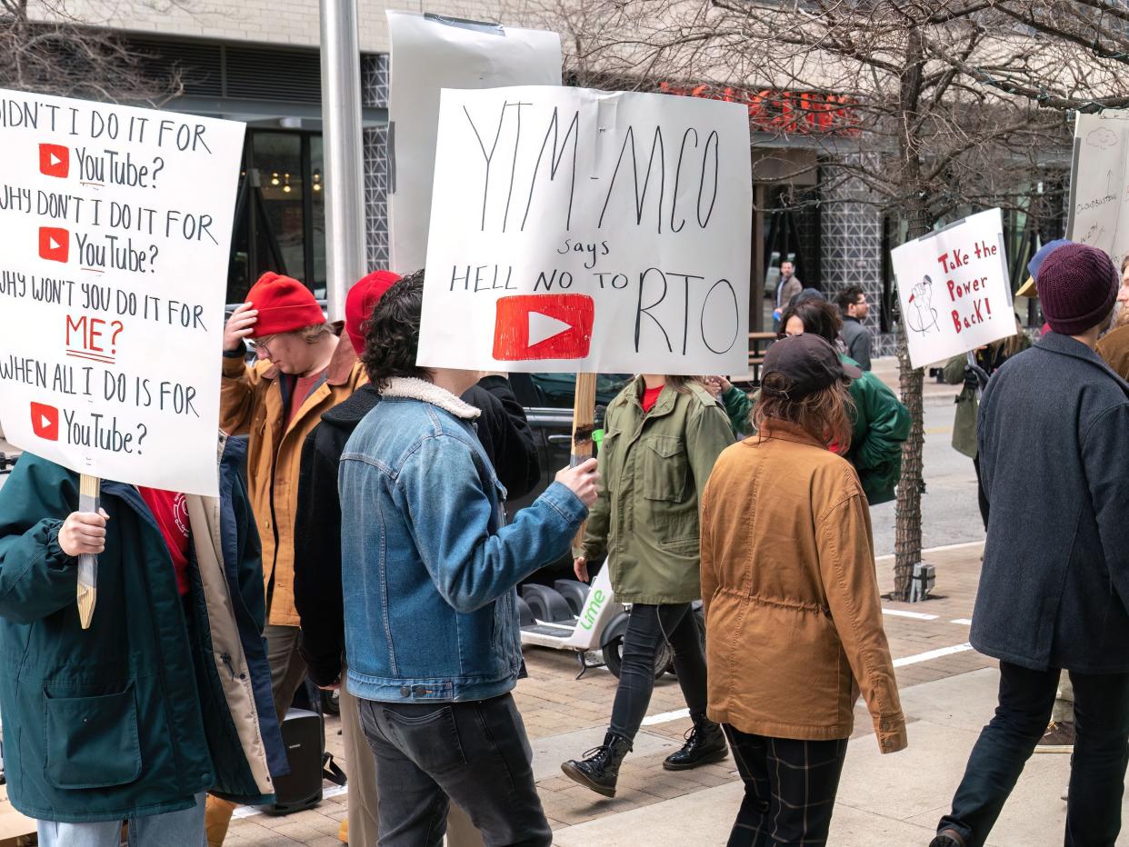 Protestors holding signs whilst on a strike outside Google's office