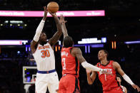 New York Knicks forward Julius Randle (30) shoots over Houston Rockets guard Kevin Porter Jr. (3) during the second half of an NBA basketball game Monday, March 27, 2023, in New York. (AP Photo/Adam Hunger)