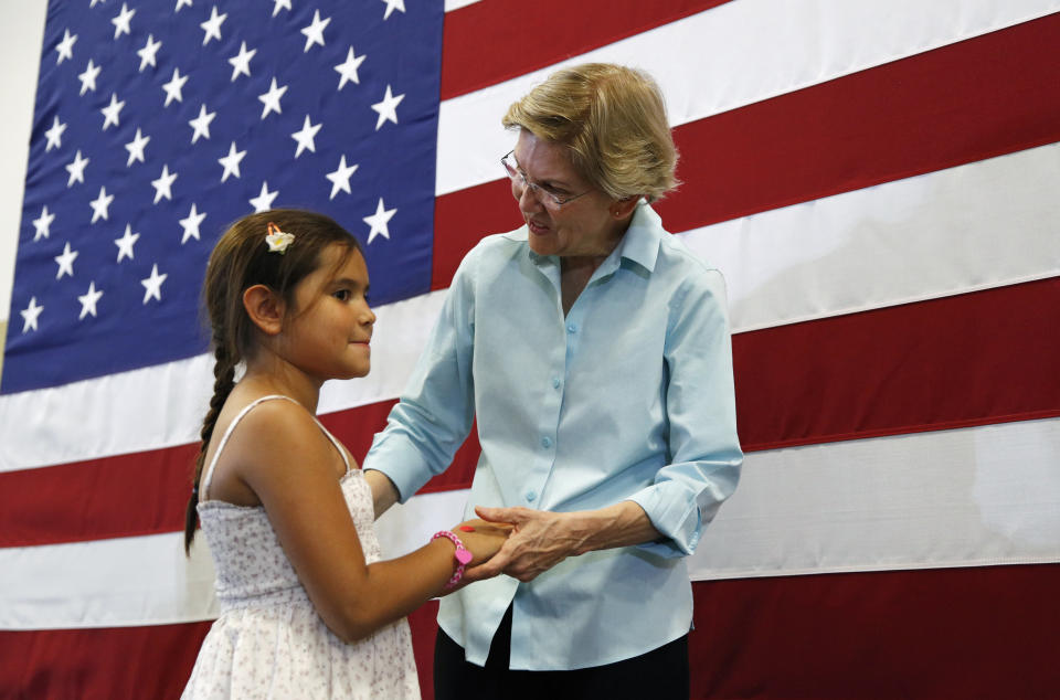 Democratic presidential candidate Sen. Elizabeth Warren, D-Mass., right, speaks with nine-year-old Melanie Weyrich during a campaign event Friday, Aug. 2, 2019, in Henderson, Nev. (AP Photo/John Locher)