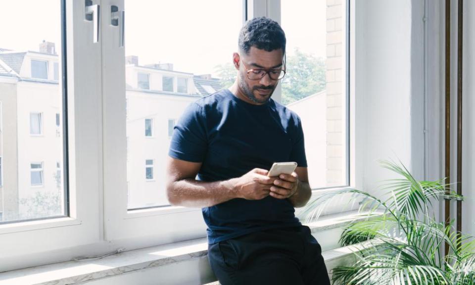 Portrait of a young man on the phone indoors