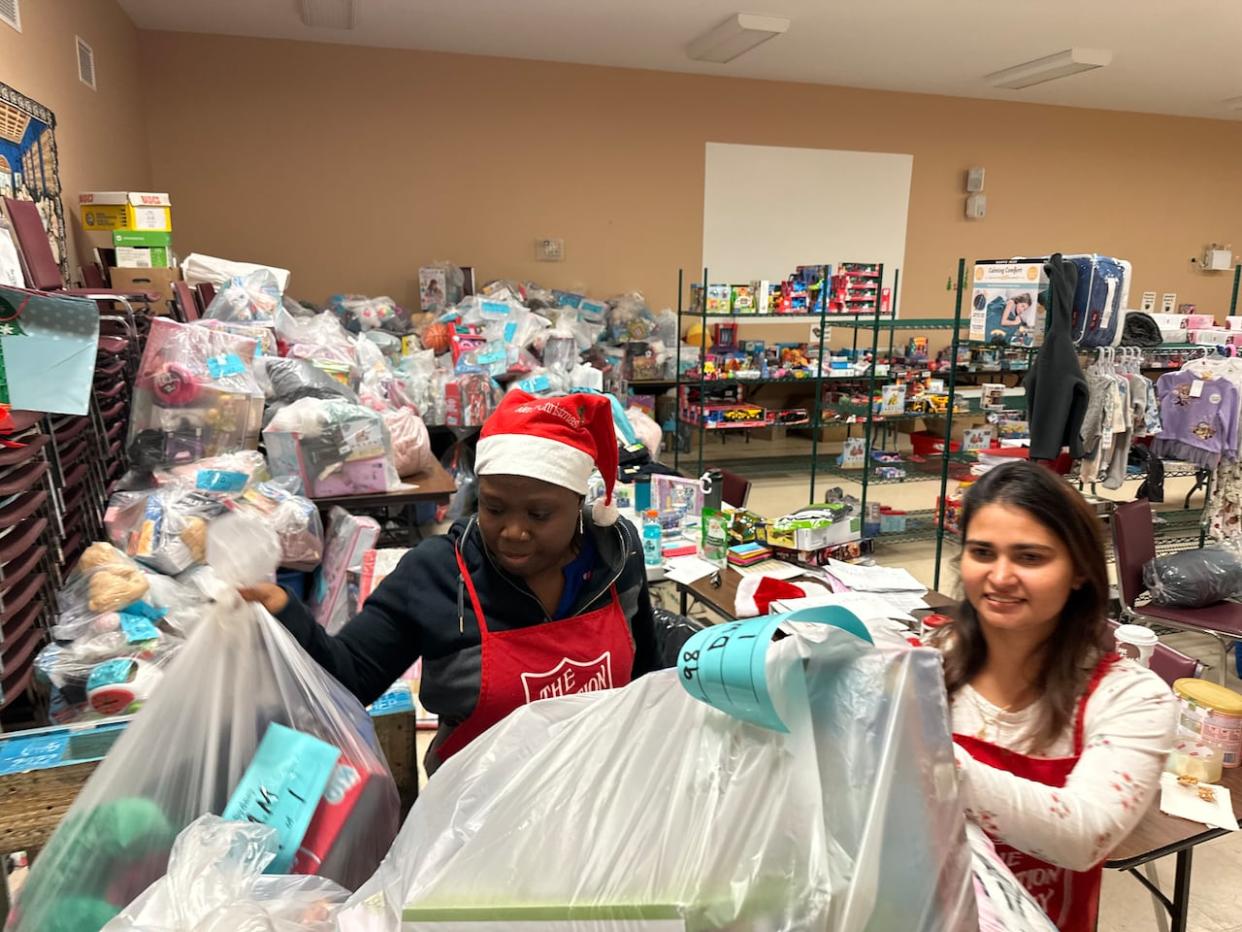 Workers at the Salvation Army in Sydney, N.S., prepare toys for the annual Christmas distribution. (Holly Conners/CBC - image credit)