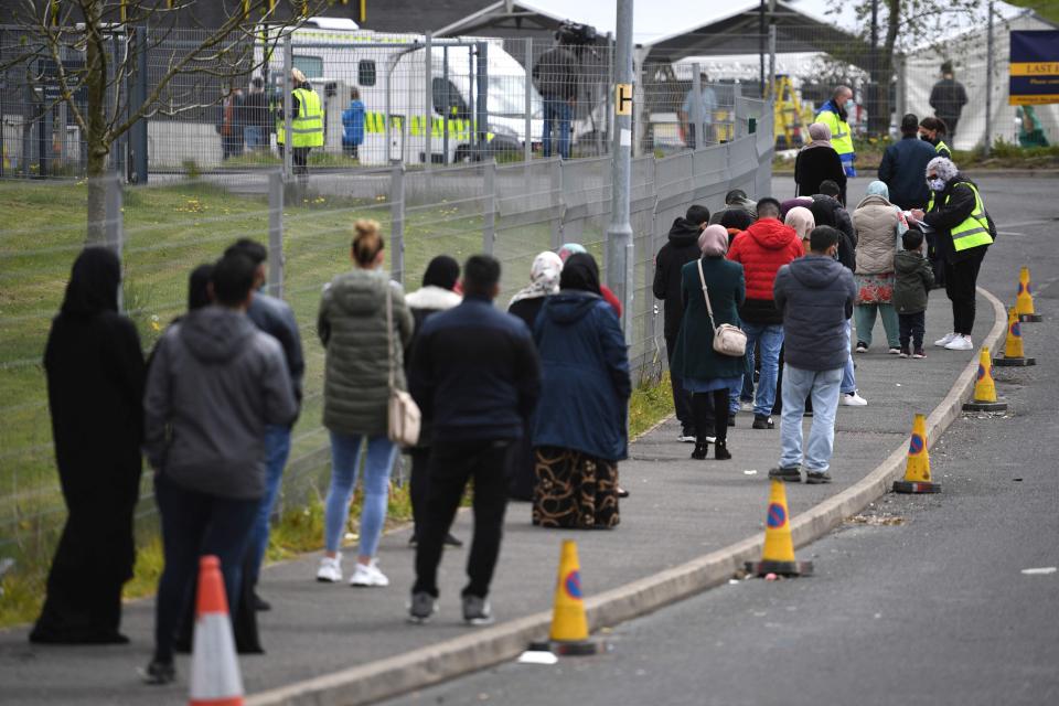 People queue at a pop-up Covid-19 vaccination centre in Bolton, Greater Manchester (AFP via Getty Images)