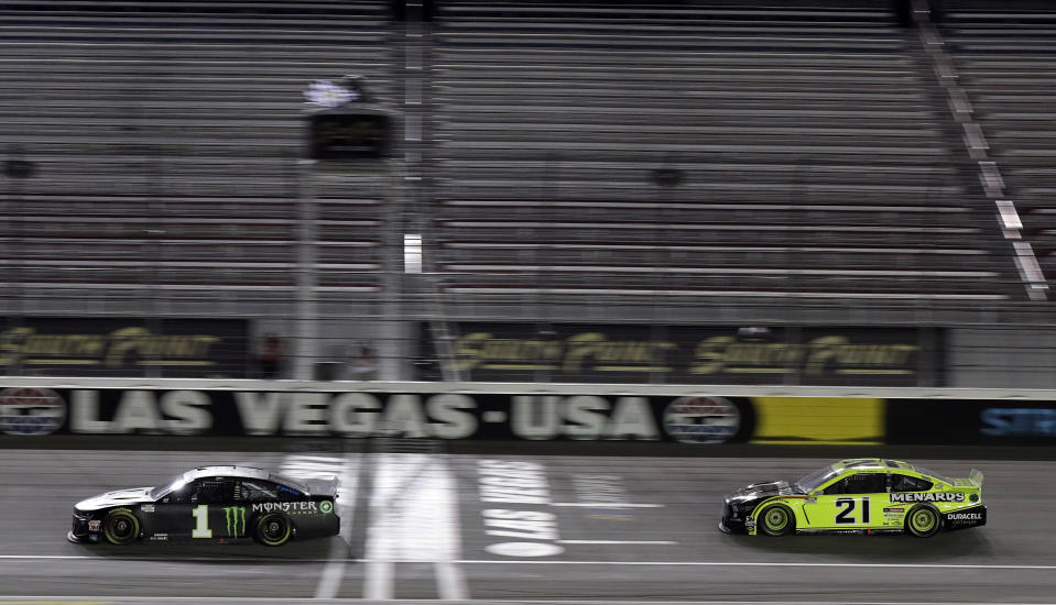 Kurt Busch (1) takes the checkered flag to win a NASCAR Cup Series auto race Sunday, Sept. 27, 2020, in Las Vegas. (AP Photo/Isaac Brekken)