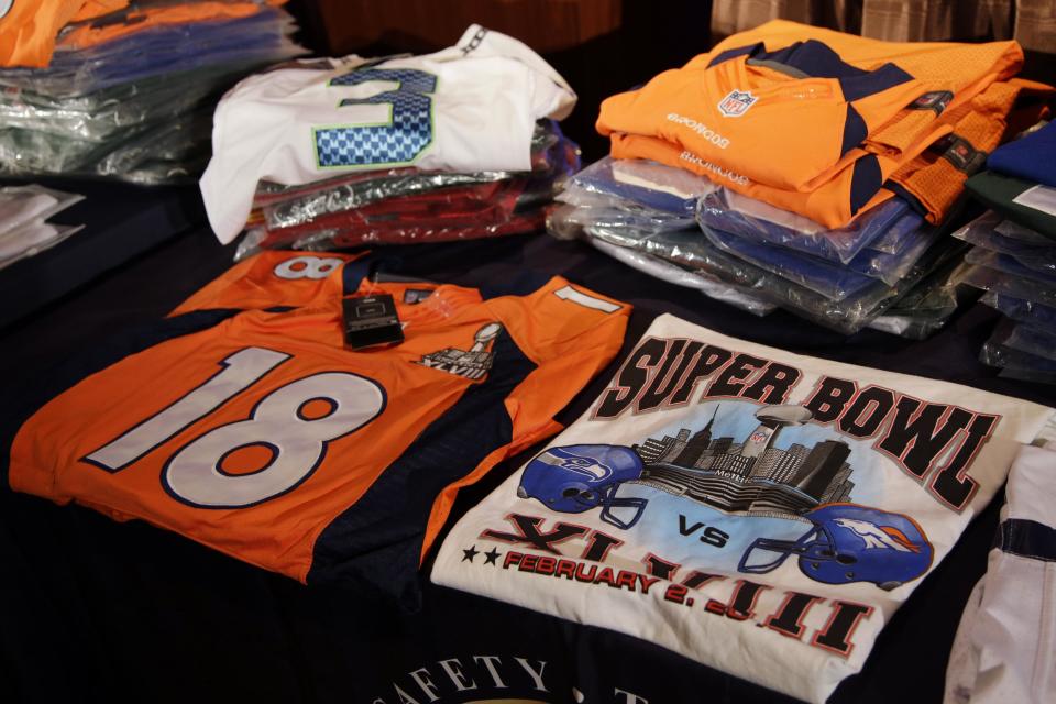 Seized counterfeit NFL merchandise is displayed before a news conference at the NFL Super Bowl XLVIII media center, Thursday, Jan. 30, 2014, in New York. (AP Photo)