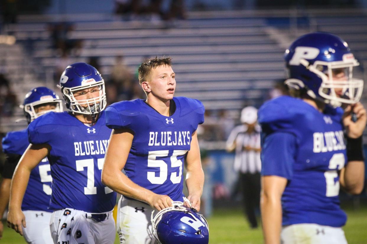 Perry's Kain Killmer heads off the field during a game against Des Moines Hoover on Friday, Aug. 25, 2023, in Perry.