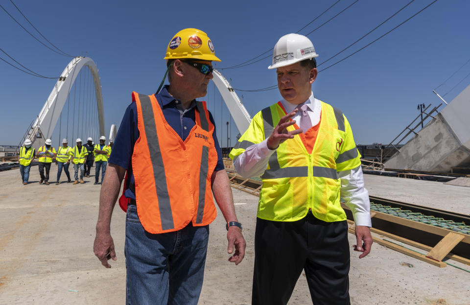 FILE - In this May 19, 2021, file photo Secretary of Labor Marty Walsh, right, visits the Frederick Douglass Memorial Bridge construction site together with District of Columbia Mayor Muriel Bowser and Secretary of Transportation Pete Buttigieg, in southeast Washington. (AP Photo/Manuel Balce Ceneta, FIle)