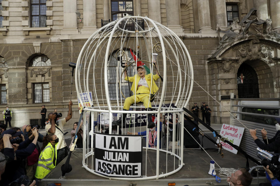 FILE - Fashion designer Vivienne Westwood sits suspended in a giant bird cage in protest against the extradition of WikiLeaks founder Julian Assange to the U.S., outside the Old Bailey court, in London on July 21, 2020. Westwood, an influential fashion maverick who played a key role in the punk movement, died Thursday, Dec. 29, 2022, at 81. (AP Photo/Matt Dunham, File)