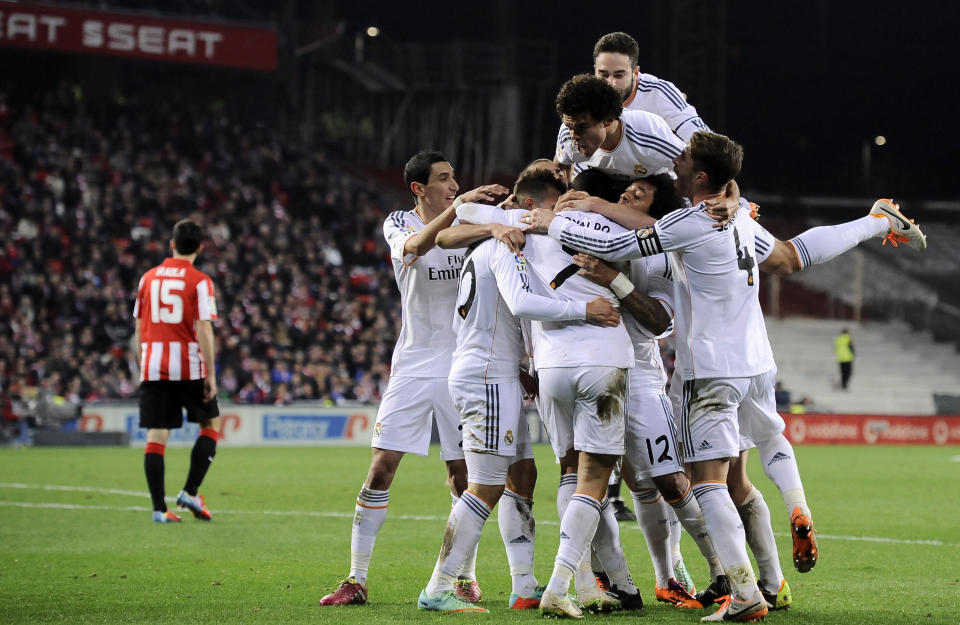 Real Madrid's players celebrates after Jese Rodriguez, surrounded by them, after scoring his goal during their Spanish League soccer match between Athletic Bilbao and Real Madrid, at San Mames stadium in Bilbao, Spain, Sunday, Feb. 2, 2014. (AP Photo/Alvaro Barrientos)
