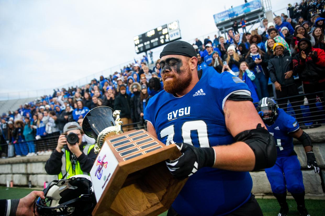 Grand Valley players lift the Anchor Bone Classic Trophy after their win over rival Ferris State Saturday, Oct. 14, 2023, at GVSU.