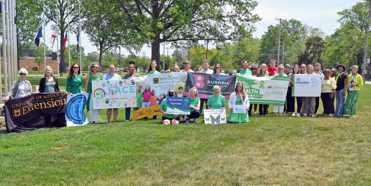 Representatives of Boone County organizations that provide mental health services stand on the lawn of Shelter Insurance on Wednesday to raise awareness for Children's Mental Health Week. 
