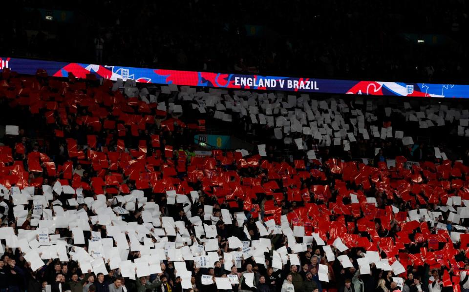 England fans hold up cards to form a giant St George's Cross