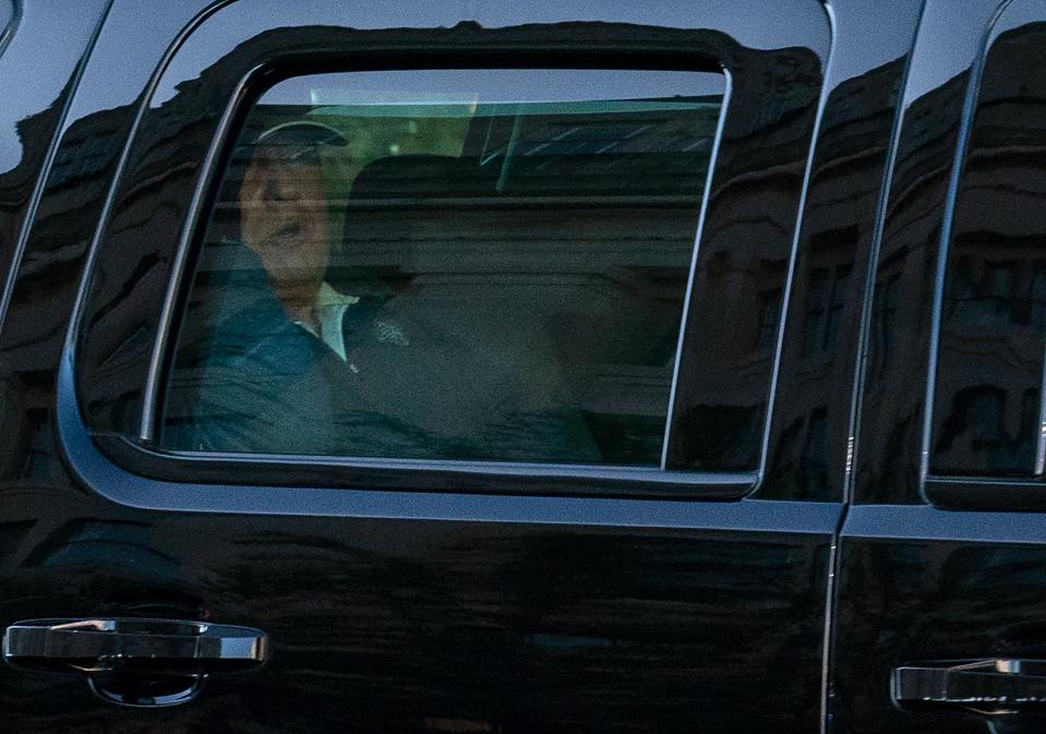 US President Donald Trump watches from the motorcade as he returns to the White House in Washington, DC, after playing golf on November 7, 2020. - Joyous celebrations erupted in Washington on Saturday after Joe Biden was declared winner of the US presidency, as several people poured into the streets of the US capital -- some of them chanting, cheering and singing in front of the White House. (Photo by ALEX EDELMAN / AFP) (Photo by ALEX EDELMAN/AFP via Getty Images)