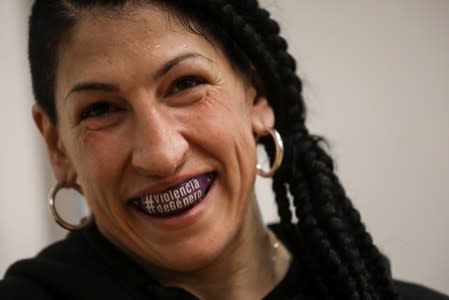 Miriam Gutierrez "La Reina", 36, wears a mouth guard that reads "Gender Violence" as she trains at her boxing gym in Madrid