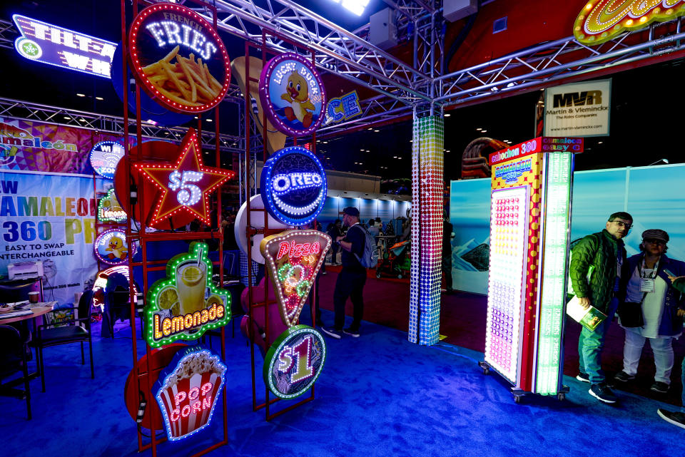 A vendor selling illuminated signs displays some of the available options during the International Association of Amusement Parks and Attractions convention Tuesday, Nov. 19, 2019, in Orlando, Fla. (AP Photo/John Raoux)