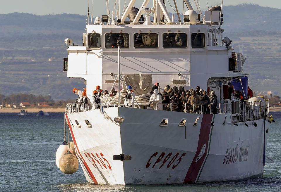 The Italian coast guard ship Peluso enters the Sicilian harbor of Catania, Italy, Monday, April 17, 2023, with some 300 migrants saved from the sea. (AP Photo/Salvatore Cavalli)