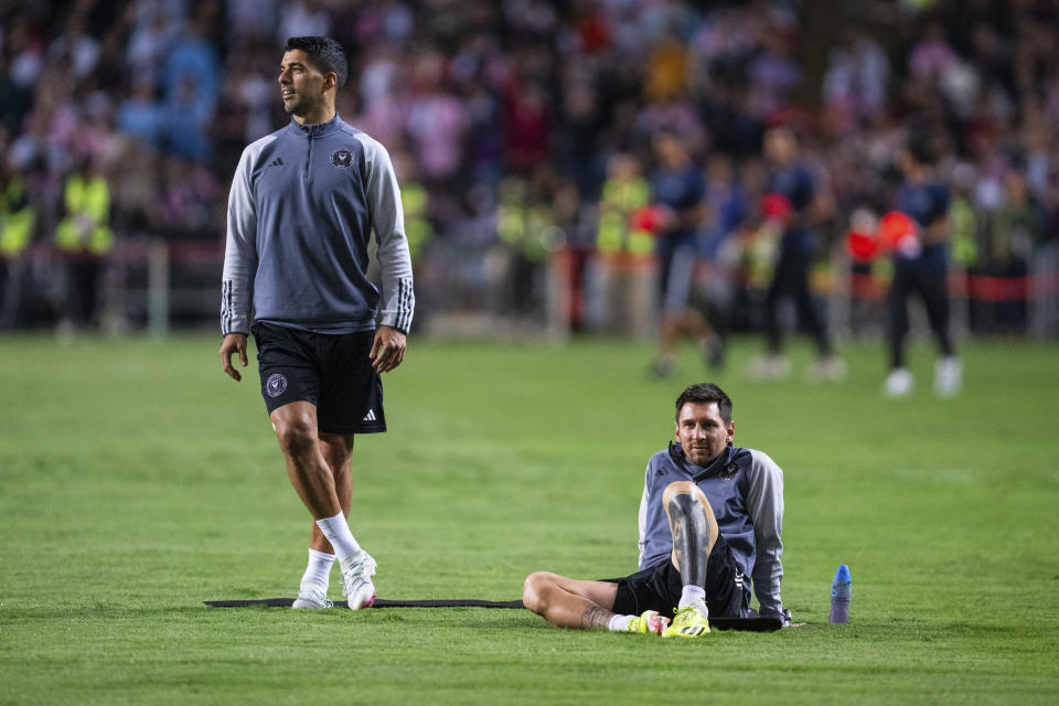 Inter Miami's Luis Suarez, left, and Lionel Messi attend a training for a friendly football match between Hong Kong Team and US Inter Miami CF at the Hong Kong Stadium in Hong Kong, Saturday, Feb. 3, 2024. (AP Photo/Louise Delmotte)