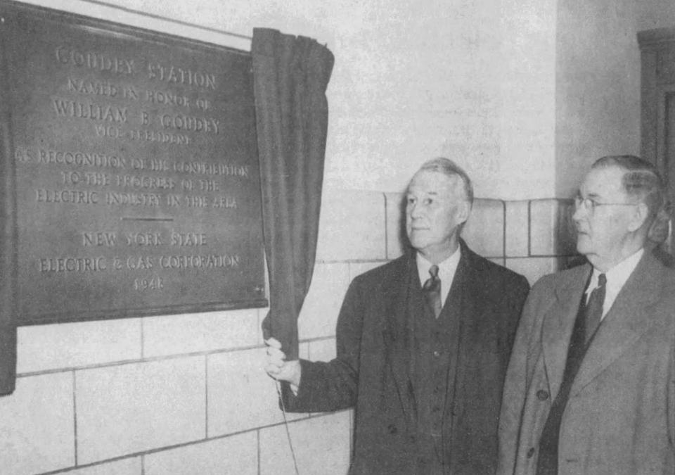 William Goudey, right, watched as the plaque dedicating the station to him is uncovered in 1948.