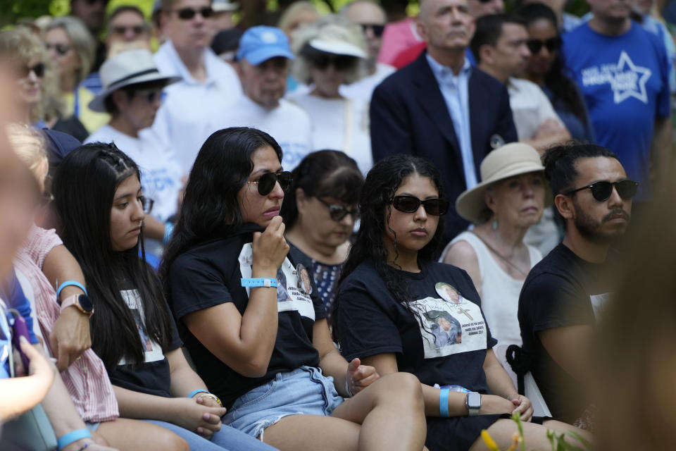 Visitors attend a remembrance ceremony in Highland Park, Ill,. Tuesday, July 4, 2023. One year after a shooter took seven lives at the city's annual parade, community members are planning to honor the victims and reclaim the space to move forward. (AP Photo/Nam Y. Huh)