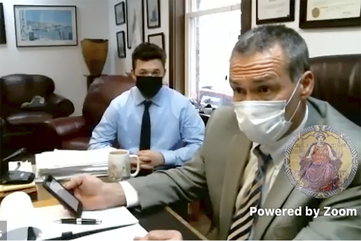 In this screen grab from live stream video, Kyle Rittenhouse, left, appears with his attorney, Mark Richards in Richards office in Racine, Wis., during a hearing at Kenosha County Court in Kenosha, Wis., on Tuesday, Jan. 5, 2021. Rittenhouse, an Illinois teenager who fatally shot two people and wounded a third amidst sometimes violent summer protests on the streets of Kenosha, Wisconsin, pleaded not guilty on Tuesday to charges including intentional homicide. (Kenosha County Court via AP)