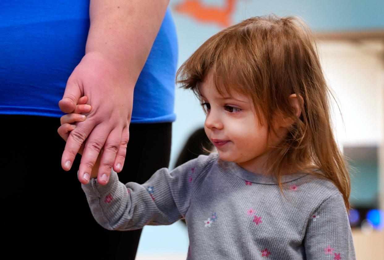 Paityn, 3, holds her teacher Hannah Huey's hand in the Cincinnati Children's Therapeutic Interagency Program, known as Tip, in Walnut Hills in December. The program has expanded "drastically," says clinical director Ann Mitchell, moving into larger space to accommodate 72, instead of 48, children ages 3 to 5.